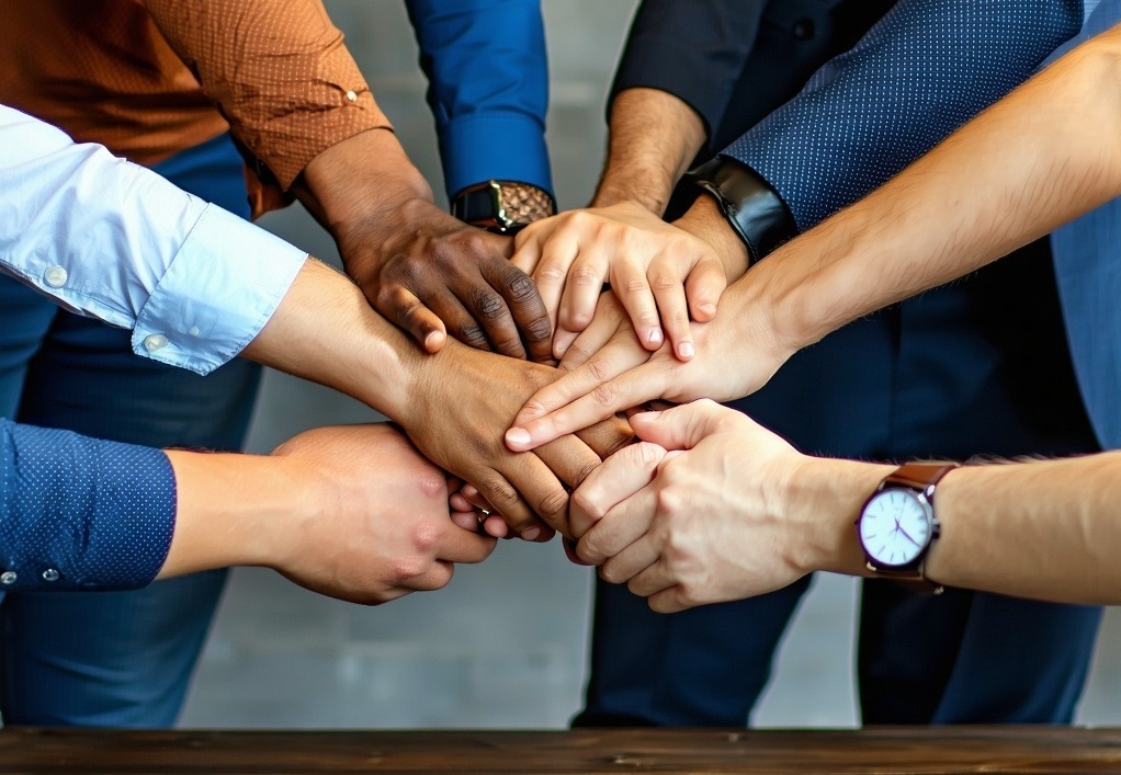 A diverse team collaborating around a table representing partnership and innovation-1
